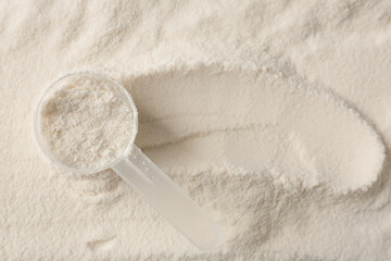 Collagen powder and scoop as background, top view. Space for text