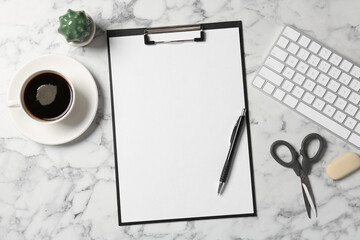 Flat lay composition with clipboard and blank paper on white marble background . Space for text