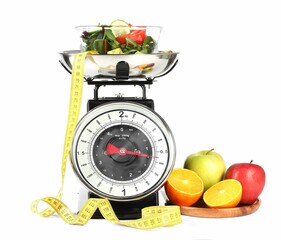 Kitchen scales with products and measuring tape isolated on white