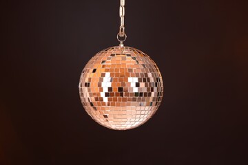 One shiny disco ball on dark background