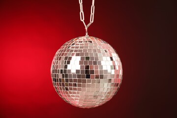 Shiny disco ball on red gradient background