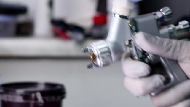 Painter Spraying Paint with Spray Gun