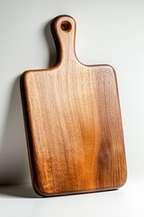 Fototapeta premium Beautiful wooden cutting board displayed against a clean, simple background in natural light for kitchen decor inspiration