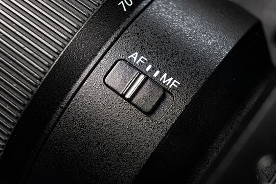 Closeup of the focus window on the camera lens. Close-up of the AF switch on the camera lens.