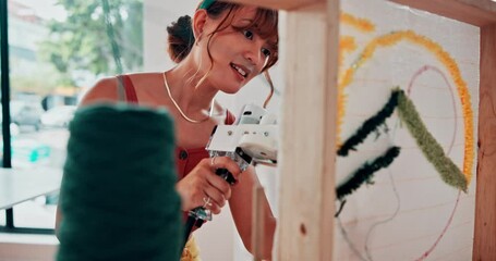 Woman, threading and wool in tool in workshop, art class and preparation for tufting in studio. Design, student or learning a skill in fashion on machine or artist in creative project on handmade rug