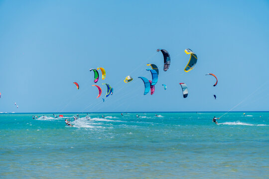 Group of Colorful Kite Surfers Riding Waves in the Red Sea, Egypt
