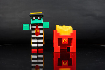 Fototapeta premium Bangkok, Thailand - April 6, 2025 : Zombie hamburglar and Minecraft fries helmet, Minecraft blind box from McDonald's collaborates.