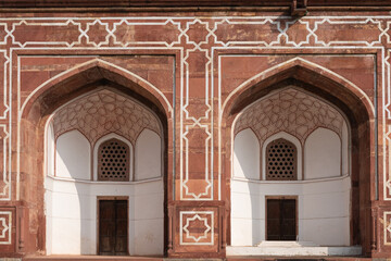 Grand arches with doorways adorned with meticulously crafted geometric designs. Photo from Humayun's Tomb in Delhi in India. UNESCO World Heritage Sites.