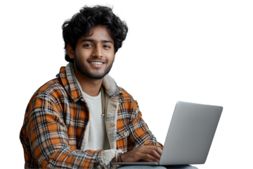 Smiling Indian male student typing on white laptop