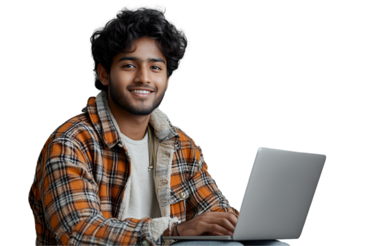 Smiling Indian male student typing on white laptop