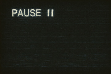Textured Black Pause Screen With Faded VHS Overlay and Static Noise