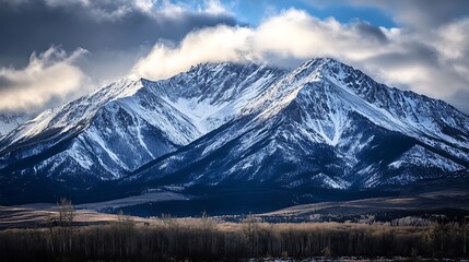 Snow Capped Mountains Landscape with Forest and Cloudy Sky