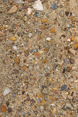 Natural river sand texture with some colored stones. Concept: Nature, wild, rocks, textures, river.