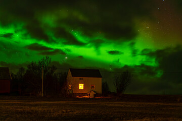 Elsgnes, Harstad, Hinn&oslash;ya, Norway - 25 February 2025 - The green and red Northern Lights in the Norwegian sky