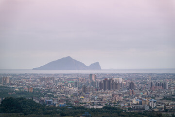 A tranquil spring morning in Yilan, Taiwan, showcases flooded paddy fields stretching towards the sea, with Turtle Island in the distance.