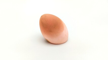 Beauty blender that has been used repeatedly so that there are makeup stains left there