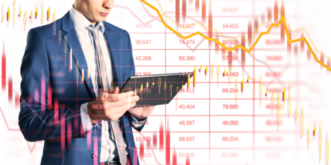 Man in suit using tablet, candlestick and line charts superimposed, light background, concept of financial crisis and market collapse
