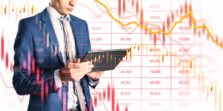 Man in suit using tablet, candlestick and line charts superimposed, light background, concept of financial crisis and market collapse