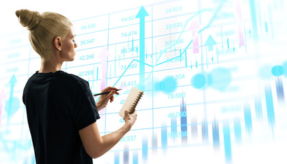 Woman holding notebook and pen analyzing abstract financial data with charts and graphs on bright background, concept of business analytics