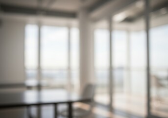 Blurry interior view of a room with large windows and a table in the foreground light and airy feel
