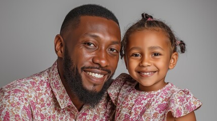 Father and daughter portrait in professional studio setting with smiling faces