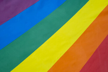 A vibrant rainbow flag symbolizes diversity, inclusion, and pride. This image showcases the colorful stripes representing unity in the LGBTQ+ community.