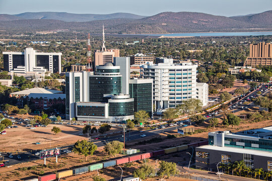 aerial view Gaborone capital city of Botswana, city center and government buildings, road and railway tracks with train