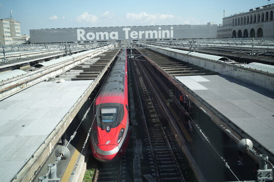 Rome, Italy - April 11, 2025: A red high-speed electric train, Frecciarossa of Trenitalia, parking at a platform in Rome Termini Train Station.