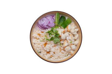 Garlic fried rice in a brown burnt ceramic plat topped with steamed crab meat, shallots and cucumber  on isolated white background, Top view.