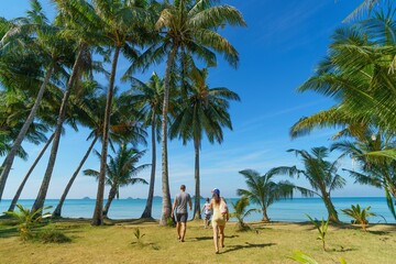 Family walks in Koh Chang island in Thailand 