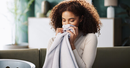 Laundry, woman and smell fabric in home for fresh scent, detergent fragrance or spring cleaning....