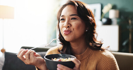 Happy, woman and eating food on sofa for dinner meal, nutrition and enjoyment with relax. Wellness snack, person and hungry with pasta bowl in living room for healthy diet, weekend break and cuisine