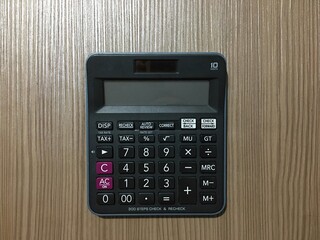 The calculator is on the floor, with rather dim lighting, the calculator is a calculating tool