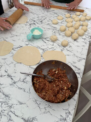 hands rolling puff pastry phyllo dough ,working process of making traditional homemade chebureki