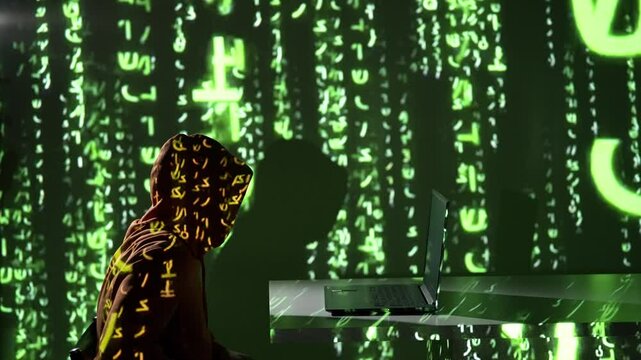 Zamaskowany haker w kapturze siada do komputera w ciemnym pokoju z zielonym kodem matrix na ścianie, symbolizując cyberatak, włam internetowy i nielegalne działania w sieci