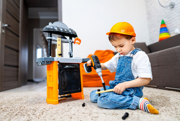 Child exploring tools at home play area. Young child in a building hat focuses on using a toy drill at home, engaged in imaginative play on a carpet.
