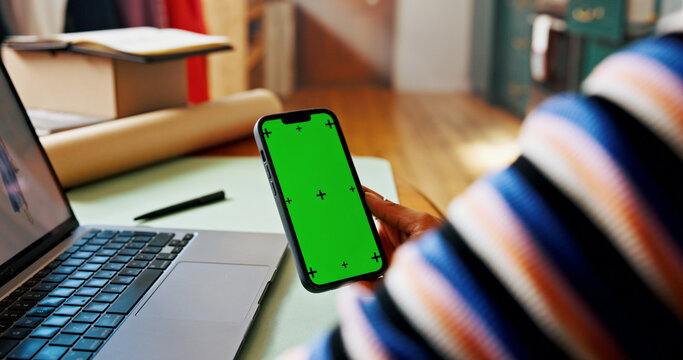 Hand, phone and green screen for small business, designer and fashion boutique startup with online sales. Mockup, woman and website space for internet store, retail ecommerce or quality control - Powered by Adobe