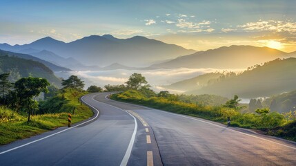 A winding road with a beautiful mountain range in the background.