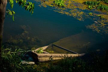 The half sink boat in river.