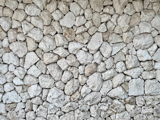 Rough gray broken stone wall background