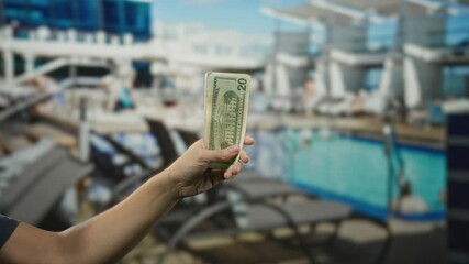 Man holding american dollars on a cruise ship by the pool, showcasing travel and lifestyle with leisure in a financial context outdoors. - Powered by Adobe