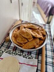 hands rolling puff pastry phyllo dough ,working process of making traditional homemade chebureki