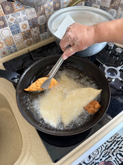 hands rolling puff pastry phyllo dough ,working process of making traditional homemade chebureki