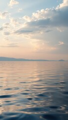 Fototapeta premium Still, glassy lake surface, gentle ripples reflecting sky, day, serenity