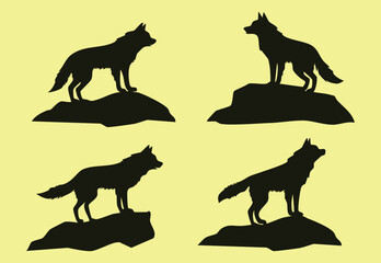 Set of four isolated silhouettes of wolves standing on rocks vector design