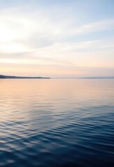 Fototapeta premium Still, glassy lake surface, subtle ripples reflecting sky, lake, peaceful lake, undisturbed