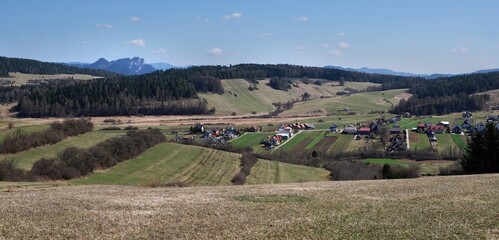 Fototapeta premium Rural scenery of buildings of village Kacwin among fields, Lesser Poland, Poland