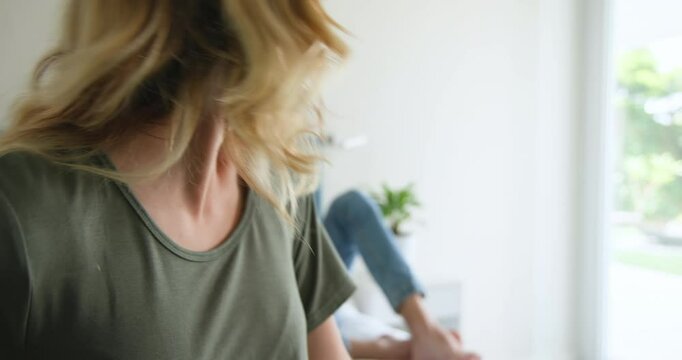 Couple embracing joyfully on bed, holding positive pregnancy test, celebrating news, at home