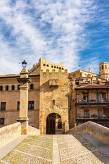 Fototapeta premium Medieval stone bridge across the river that passes by the medieval town of Valderrobres, Teruel, Spain.
