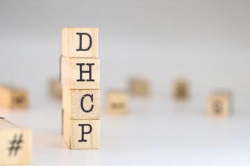 Dynamic Host Configuration Protocol acronym. word dhcp written on wooden cubes isolated on white background with copy space. Concept of concept of network conceptions, ip addressing